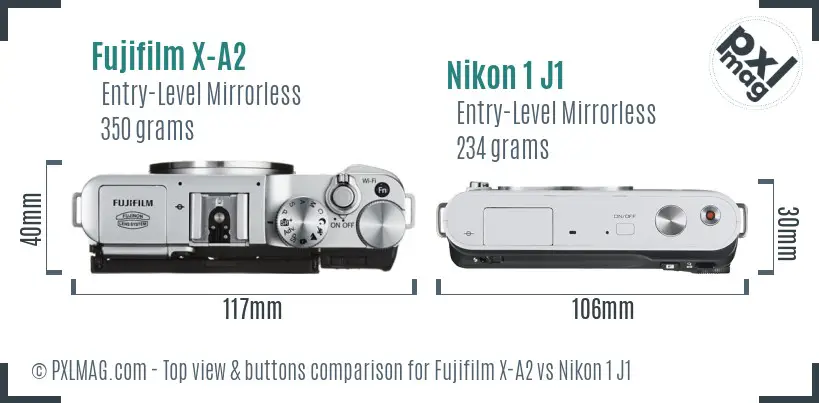 Fujifilm X-A2 vs Nikon 1 J1 top view buttons comparison