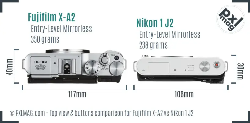 Fujifilm X-A2 vs Nikon 1 J2 top view buttons comparison