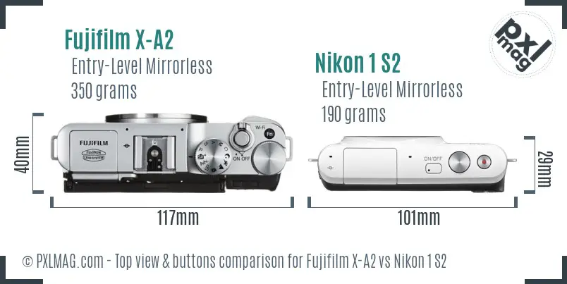 Fujifilm X-A2 vs Nikon 1 S2 top view buttons comparison