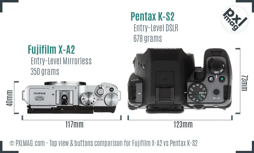 Fujifilm X-A2 vs Pentax K-S2 top view buttons comparison