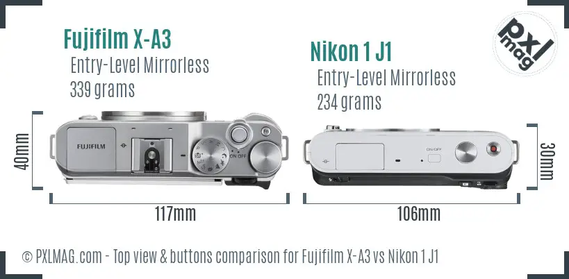 Fujifilm X-A3 vs Nikon 1 J1 top view buttons comparison