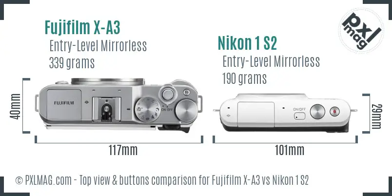 Fujifilm X-A3 vs Nikon 1 S2 top view buttons comparison