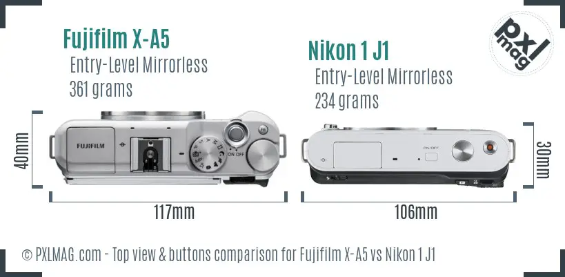 Fujifilm X-A5 vs Nikon 1 J1 top view buttons comparison