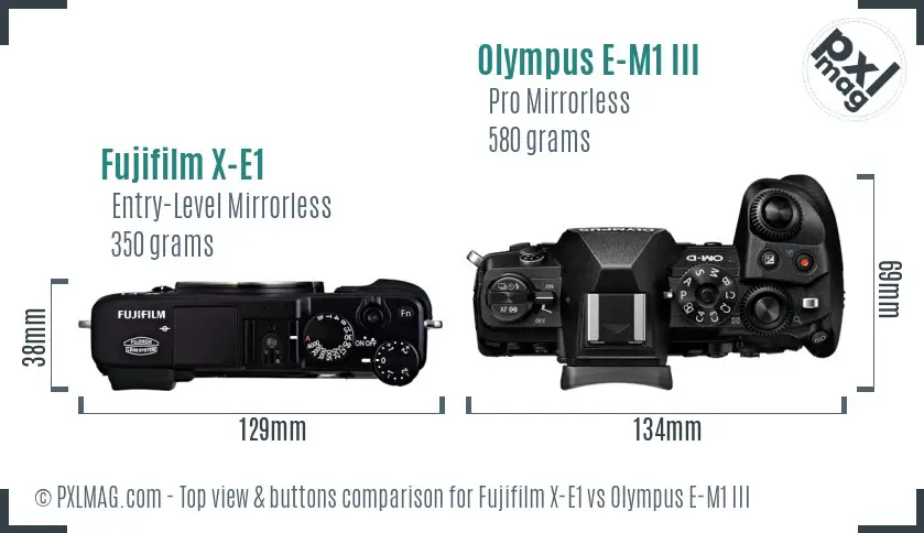 Fujifilm X-E1 vs Olympus E-M1 III top view buttons comparison