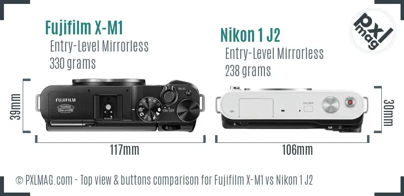 Fujifilm X-M1 vs Nikon 1 J2 top view buttons comparison