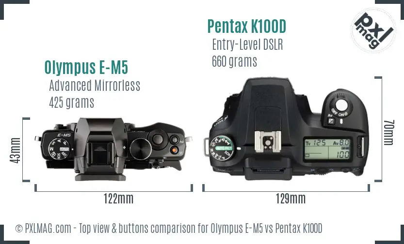 Olympus E-M5 vs Pentax K100D top view buttons comparison