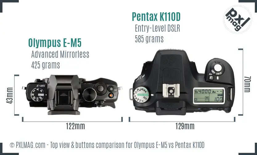 Olympus E-M5 vs Pentax K110D top view buttons comparison