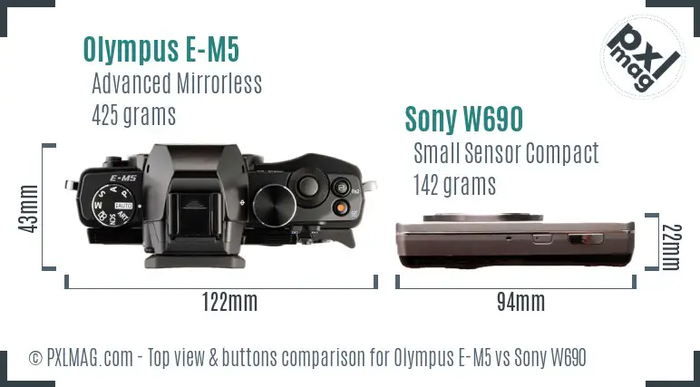 Olympus E-M5 vs Sony W690 top view buttons comparison Olympus E-M5 vs Sony W690 top view buttons comparison