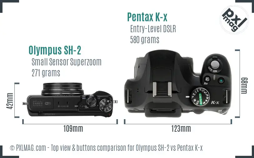 Olympus SH-2 vs Pentax K-x top view buttons comparison
