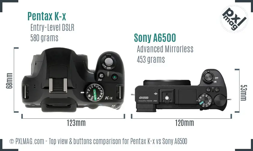Pentax K-x vs Sony A6500 top view buttons comparison